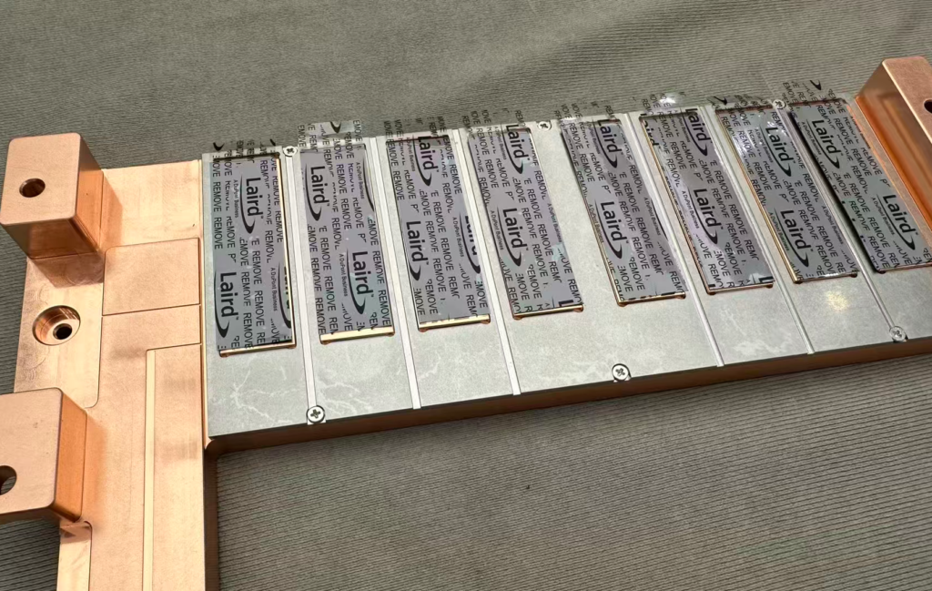 Thermal Interface Pads on Cold Plate Assembly Thermal interface pads bonded to a copper cold plate assembly for heat spreading
